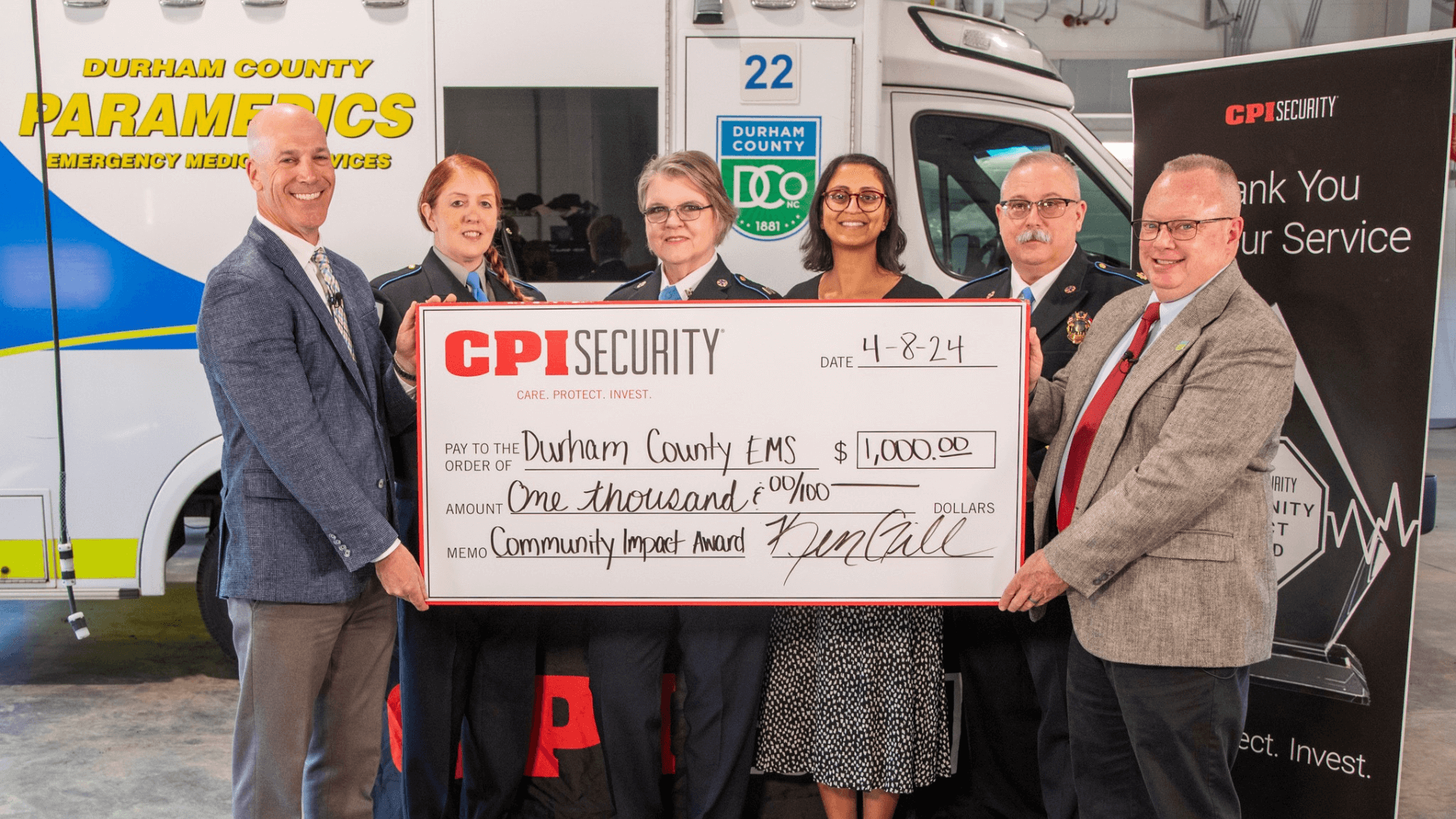 Durham County EMS and CPI Security holding check